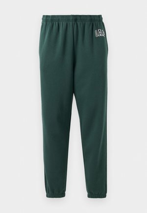 Green sweatpants made of soft fabric, featuring an elastic waistband, tapered legs, and a small GAP logo on the left hip.