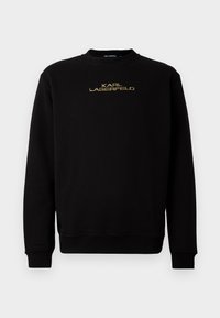 Sweatshirt preto com mangas longas e decote redondo. Apresenta o logótipo "KARL LAGERFELD" em bordado dourado na parte da frente. Textura suave.