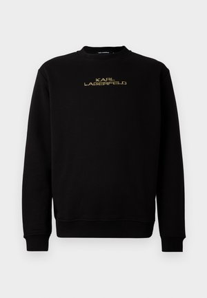 Svart genser med lange ermer og rund hals. Har "KARL LAGERFELD" logo i gull broderi på forsiden. Glatt tekstur.