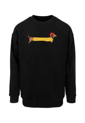 Schwarzer Sweatshirt mit einem Cartoon-Design eines Dackels. Der Hund ist elongated, trägt einen gelben Mantel und einen roten Hut, auf dem schwarzen Stoff.