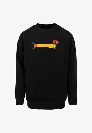 Schwarzer Sweatshirt mit einem Cartoon-Design eines Dackels. Der Hund ist elongated, trägt einen gelben Mantel und einen roten Hut, auf dem schwarzen Stoff.