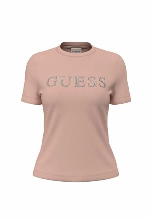 Camiseta de manga corta de color rosa claro con logo "GUESS" en pedrería plateada centrado en el frente, cuello redondo y corte ceñido.