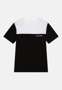 Black and white short-sleeve t-shirt featuring a horizontal color block design and Calvin Klein logo in black on the front lower left.