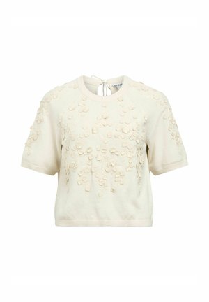 Haut court en tricot à manches courtes de couleur crème avec un col rond, orné d'appliqués floraux 3D dispersés sur le devant et les manches, et une petite fermeture à nouer au dos.