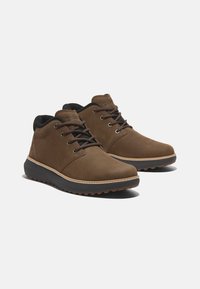 Brown suede ankle boots with a black textile collar, lace-up design, rubber outsole, and contrasting stitching detail.