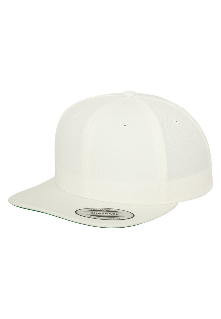 White snapback cap with a flat brim, made of textured fabric. Features ventilation holes and a circular brand logo on the underside.