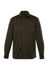 Donkergroene shirt met knopen, gemaakt van zachte stof, met lange mouwen, twee borstzakken en een puntige kraag.