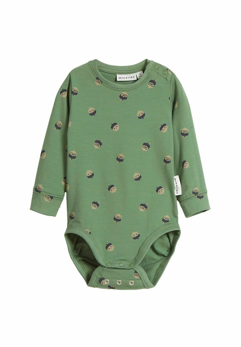 Grön långärmad bodysuit i mjuk bomull, med ett mönster av tecknade ansikten i olika färger. Tryckknappar i botten.