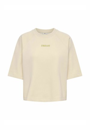 Sweatshirt à manches courtes de couleur crème avec le mot « DREAM » brodé en jaune, centré sur la poitrine, avec un col rond.