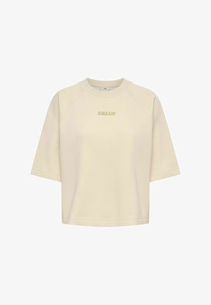 Hanorac cu mâneci scurte, culoare crem, cu inscripția "DREAM" brodată în galben, plasată în centru pe piept, având o decolteu rotund.