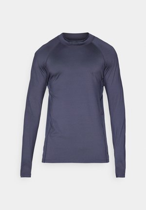 Camisola atlética de mangas longas em azul-marinho escuro, feita de um tecido suave e leve, com mangas raglan e decote em crew.