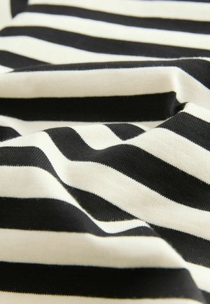 Close-up of black and white horizontal striped fabric with soft folds and visible knit texture.