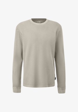 Beige Langarmshirt mit Waffelstrick, Rundhalsausschnitt, gerippten Bündchen und kleinem schwarzem Etikett an der linken Seitennaht.