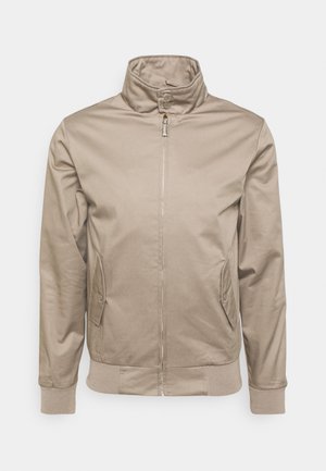 Giacca beige con colletto alto, zip frontale e tasche laterali. Presenta polsini e orlo a costine, realizzata in un tessuto liscio.