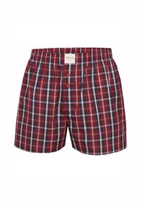 Rode en marineblauwe geruite boxershort met een elastische tailleband, twee knopen aan de voorkant en een label in het midden bovenaan. Katoenen stof, relaxed fit.
