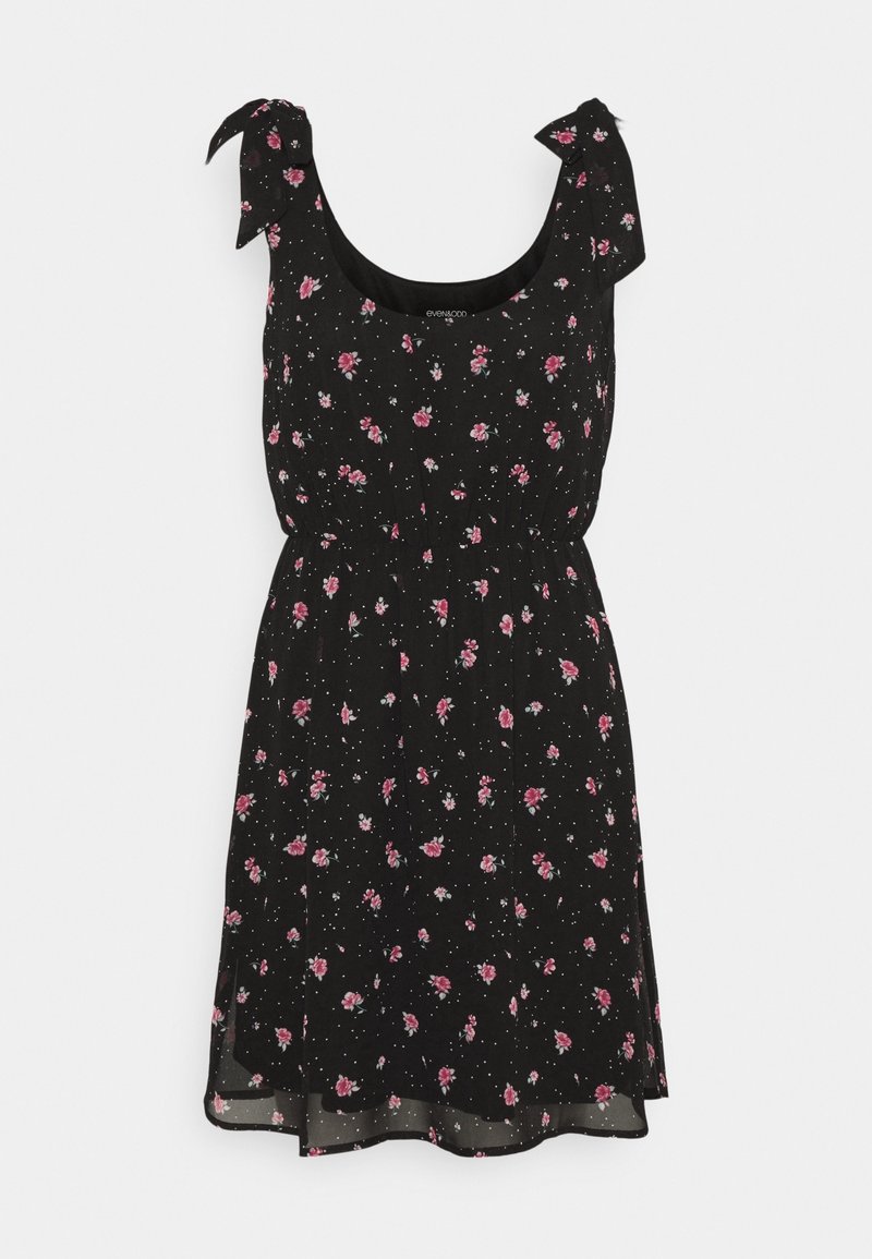Robe noire sans manches avec imprimé floral rose, bretelles à nouer, taille cintrée et jupe légèrement évasée.