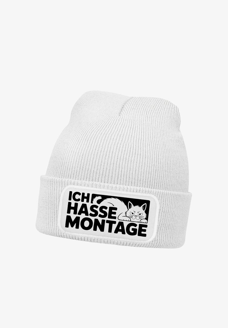 White knitted beanie featuring a black patch with the text "ICH HASSE MONTAGE" and an illustration of a cat. Text is bold against the patch.