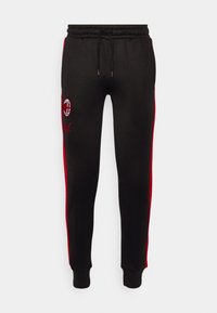 Schwarze Jogginghose mit roten Seitenstreifen, elastischem Bund und Kordelzug. Mit gesticktem Logo am linken Oberschenkel. Weicher Stoff.