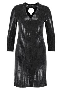 Svart paljettklänning med långa ärmar, en nyckelhålskant och en figursydd silhuett. Har en glittrande textur med en slät innervägg.