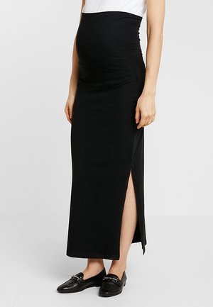 Jupe de maternité noire en tissu extensible, dotée d'une taille haute et d'une fente latérale. Conception longue jusqu'au sol avec une texture lisse.