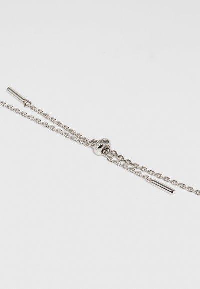 Silver bracelet with a double chain design, featuring a round clasp and cylindrical accents. Clean, polished finish with a smooth texture.