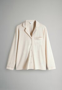 Light beige pajama shirt with a button-down front, long sleeves, collared neck, and small chest pocket. Soft, textured fabric.