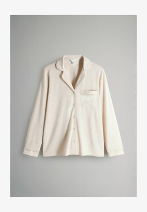 Lys beige pyjamashirt med knaplukning fortil, lange ærmer, krave og lille brystlomme. Blødt, struktureret stof.