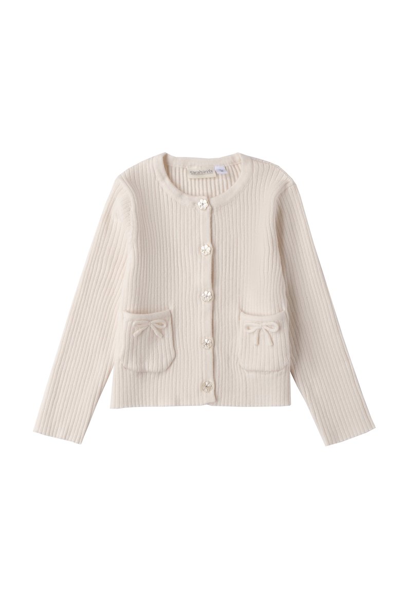Cardigan a coste crema con maniche lunghe, due tasche frontali e bottoni a forma di fiore. Presenta fiocchi sulle tasche per un tocco di eleganza.