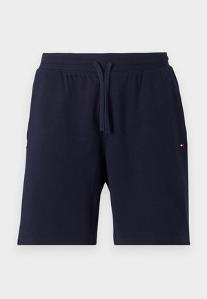 Pantalones cortos de algodón azul marino con cintura elástica y cordón. Presenta bolsillos laterales y un pequeño logo en la pierna izquierda.