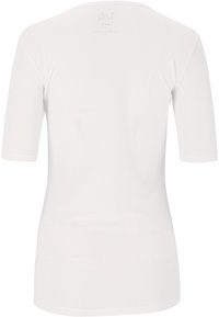 Hvid kortærmet skjorte med en tekstureret mesh-stof. Har en rund halsudskæring og en let indsnævring i taljen. Ingen synlige logoer eller mønstre.