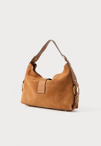 Brown suede handbag with a curved shape, tan leather strap, and gold-tone hardware accents. Features a visible flap closure.