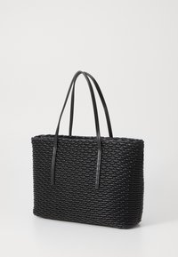 Svart vevd tote-veske med glatte skinnhåndtak, rektangulær form, teksturert overflate og en strukturert design.