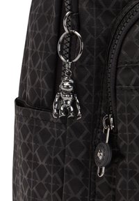 Black backpack with a geometric pattern, featuring a silver monkey keychain, a zipper pull, and a side pocket for added functionality.