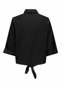 Top nero con collo a camicia, maniche a tre quarti, motivo ad occhiello e dettaglio con lacci sul retro. Tessuto testurizzato con ritagli floreali.