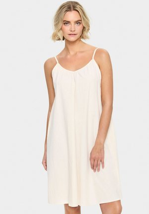 Crème-kleurige slipdress met spaghettibandjes, een losse silhouet, en een zachte textuur, met een geplooide halslijn en die net boven de knieën valt.