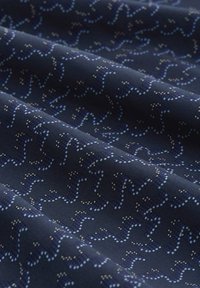 Navy fabric featuring a wavy pattern in shades of blue and cream, with a smooth texture and a subtle sheen.