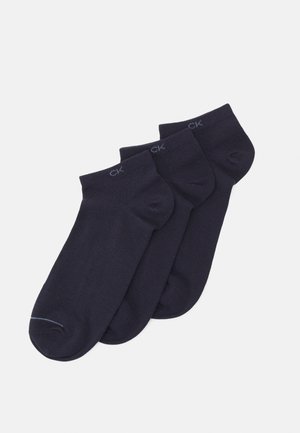 Three pairs of ankle socks in dark navy, made from a smooth, stretchy material. Each pair features a subtle logo near the cuff.