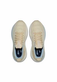 Beežid jooksujalatsid tekstuurse võrgu pealmise osaga, tasase paelaga, siniste aktsentidega ja tumeda kontraste sisetallaga. Bränding nähtav keelel.