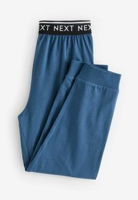 Des joggers bleus en tissu doux disposent d'une taille élastique noire avec le logo "NEXT" en blanc. Les bords des chevilles sont côtelés pour un maintien sécurisé.