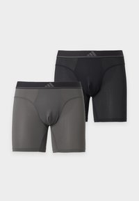 Deux paires de boxers à texture en maille en noir et gris foncé avec une ceinture noire comportant un petit logo.