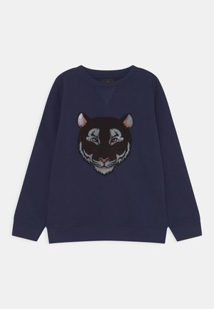 Sweatshirt navy à col rond avec un visage de tigre brodé en détails dans des nuances de noir, blanc et argent, avec des manches longues.