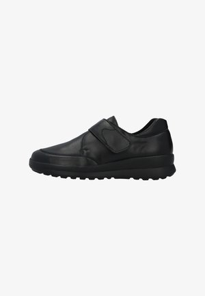 Black leather sneaker with a rounded toe, adjustable Velcro strap, and textured rubber sole for grip and stability.