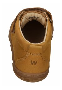 Hellbraune Lederstiefel mit runder Öffnung, hellbrauner Innenausstattung, dekorativen Nähten und einer braunen Gummisohle. Mit einem ‚W‘ gekennzeichnet.