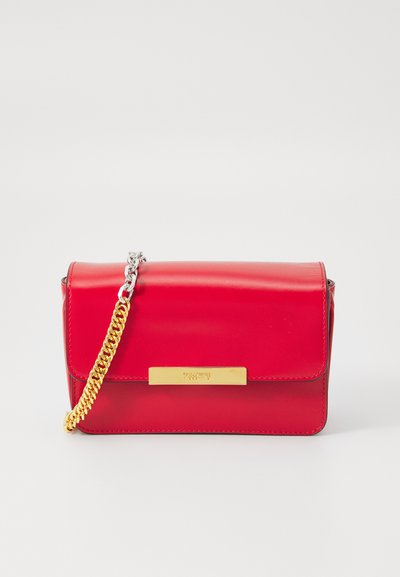 Red leather handbag with a flap closure, gold hardware, and a removable chain strap. Smooth texture with a subtle shine and embossed logo.