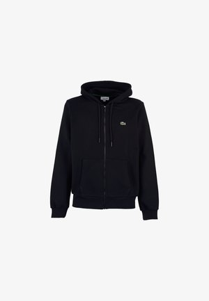 Haut à zip noir en mélange de coton. Comprend une poche kangourou, une capuche avec cordon de serrage et un petit logo vert brodé.