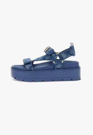Niebieska platforma sandałów z grubą podeszwą, paski z materiału dżinsowego z nadrukiem monogramu i regulowanymi zapięciami na rzep.