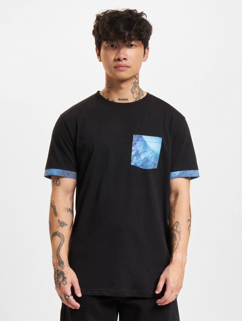 Black cotton t-shirt featuring a blue patterned pocket and matching blue cuffs, with short sleeves and a round neckline.