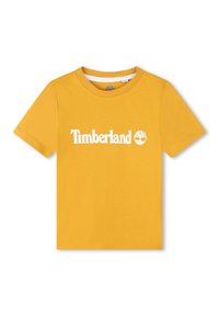 Camiseta de algodón amarilla con mangas cortas y cuello redondo. Presenta un logotipo blanco de "Timberland" y un emblema de árbol en la parte frontal.