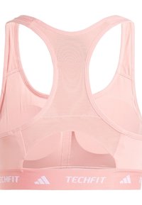 Sujetador deportivo rosa claro con espalda de malla, tirantes anchos y una banda elástica de marca que dice "TECHFIT". Tejido suave con un diseño sin costuras.