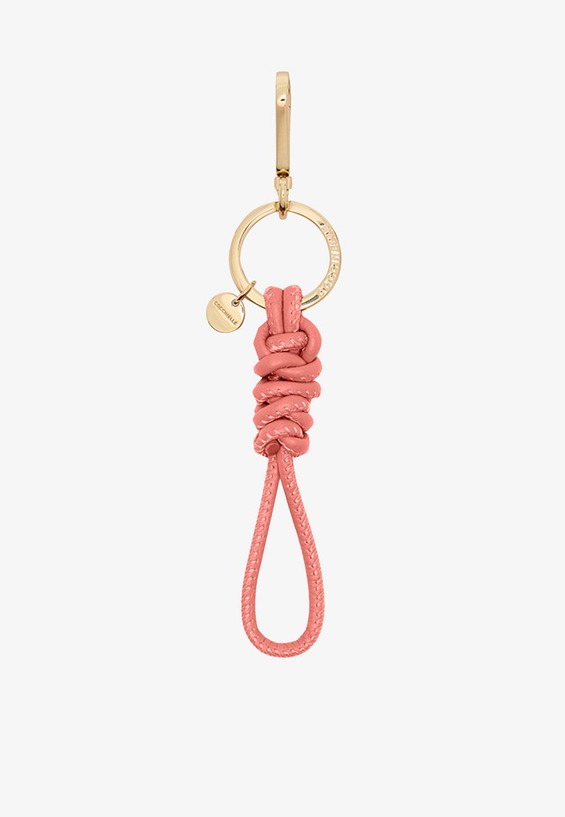 Leather keychain in soft pink, featuring a knotted design, a gold metal ring, and a small engraved pendant attached. Smooth texture.